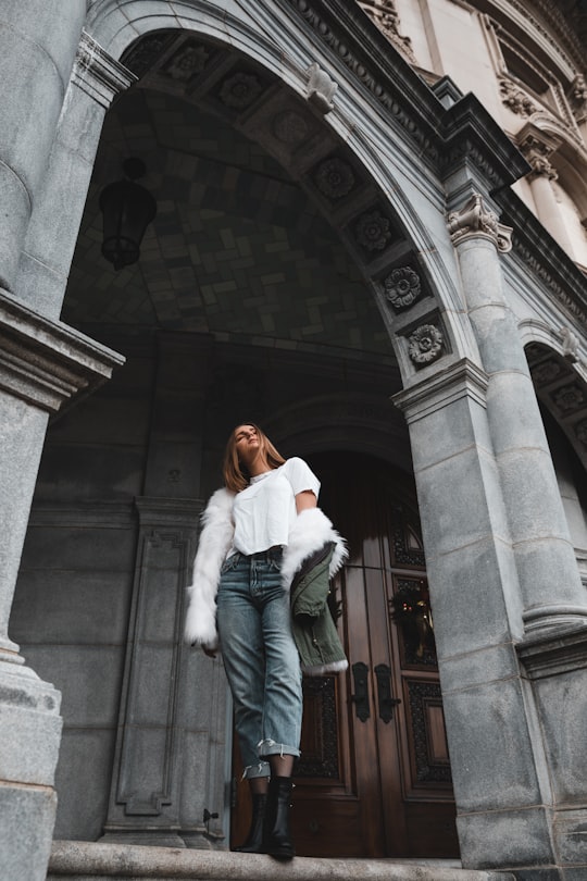 woman in white coat standing in Boston United States