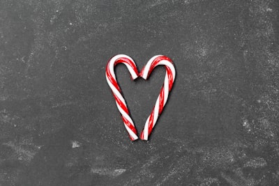 two red-and-white candy canes on gray surface candy cane google meet background