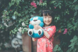 A joyful child holding a newly created plush toy.