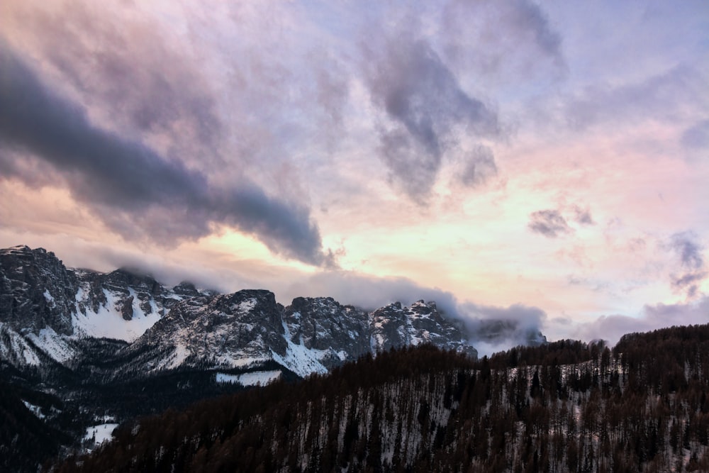 snow-capped mountain under blue and white sky