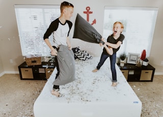 boy and girl having pillow fight