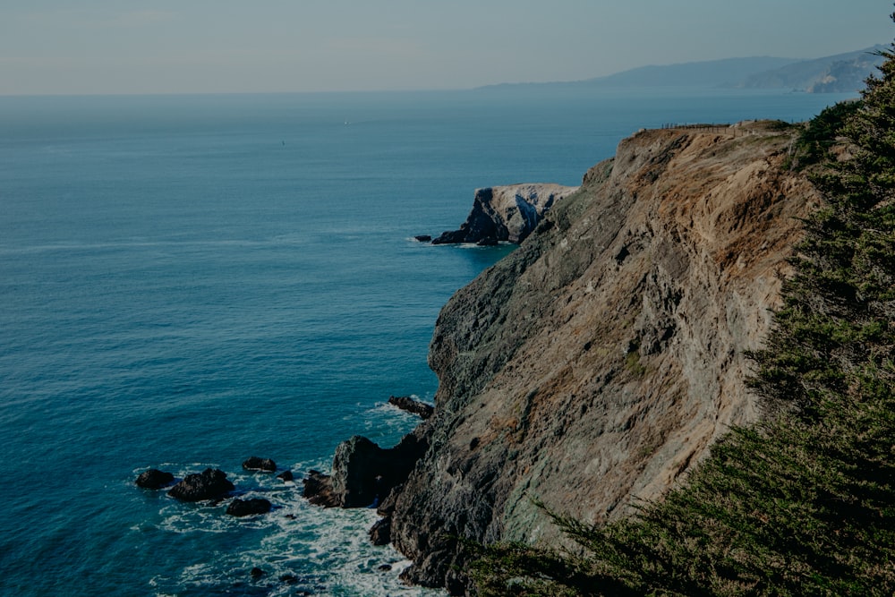 rock formation surrounding by body of water