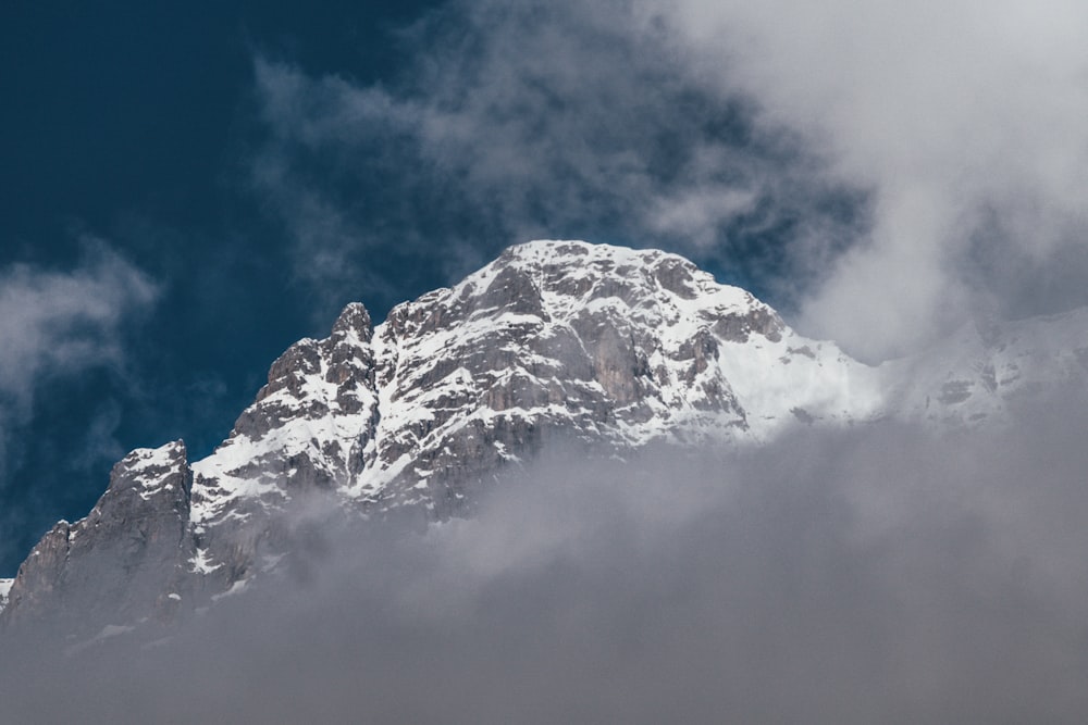 snow covered mountain under blue cloudy sky