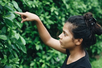Close-up of a local guide pointing out native plants in the cerrado.
