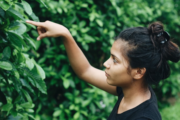 Close-up of a local guide pointing out native plants in the cerrado.