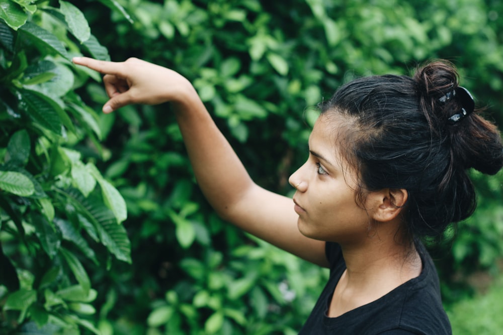 woman looking at the plant