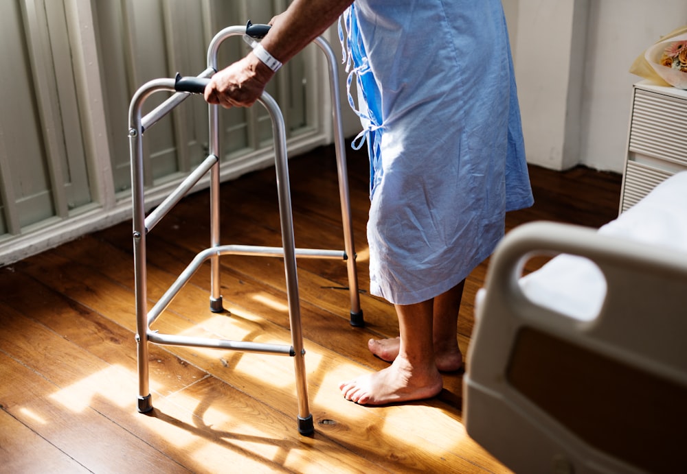 man standing using adult walker inside room