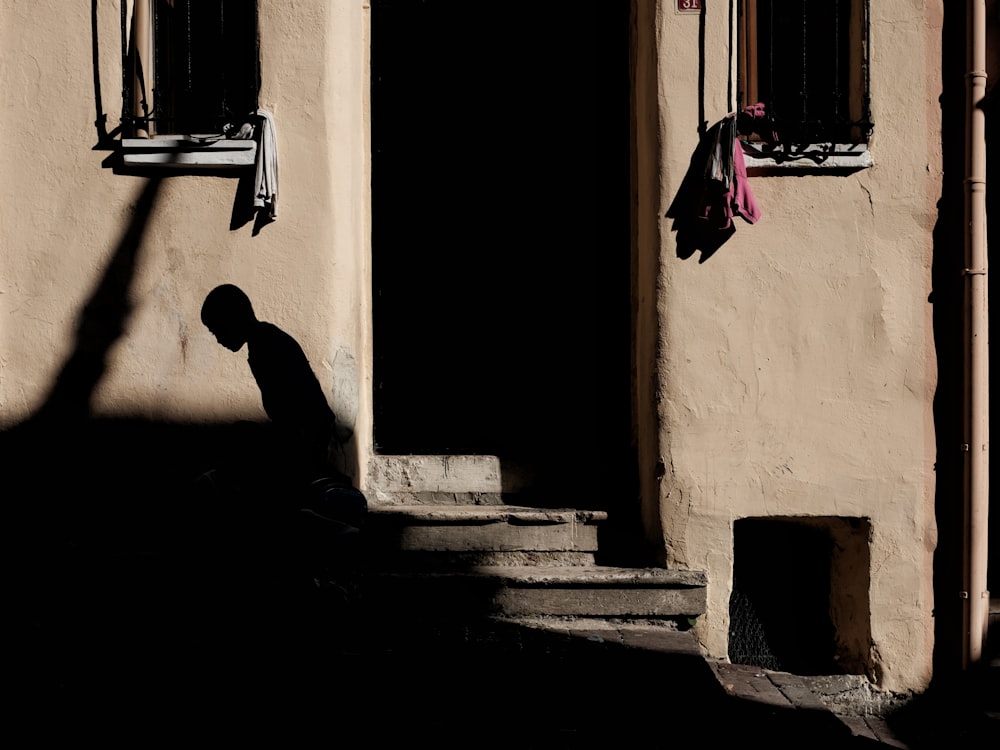 silhouette of person beside door
