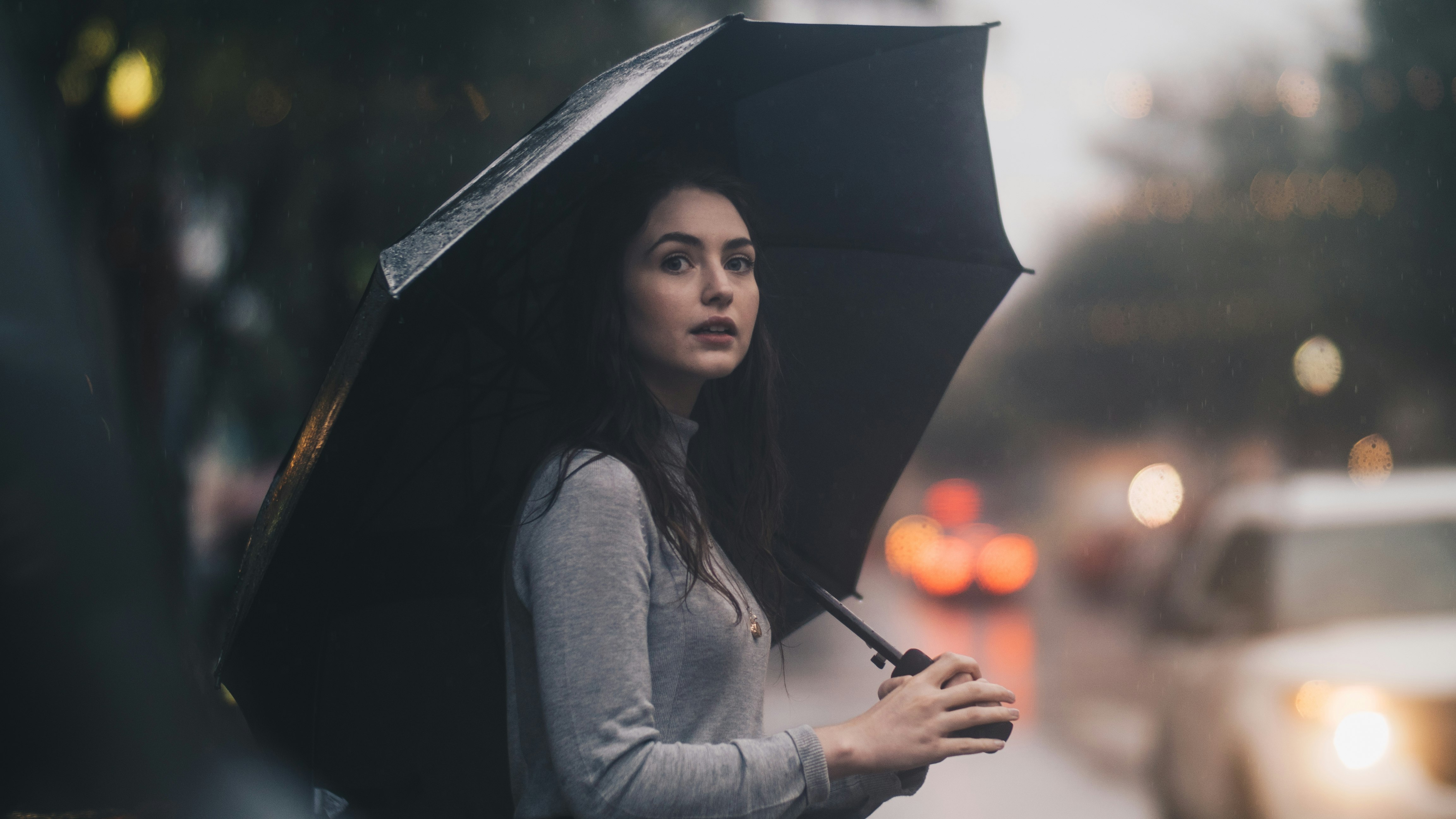 woman on the street holding umbrella