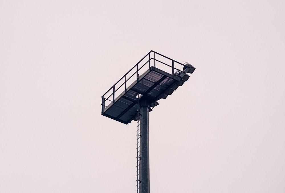 low angle photo of black metal tower at daytime