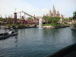 A magical theme park scene with joyful families and iconic attractions