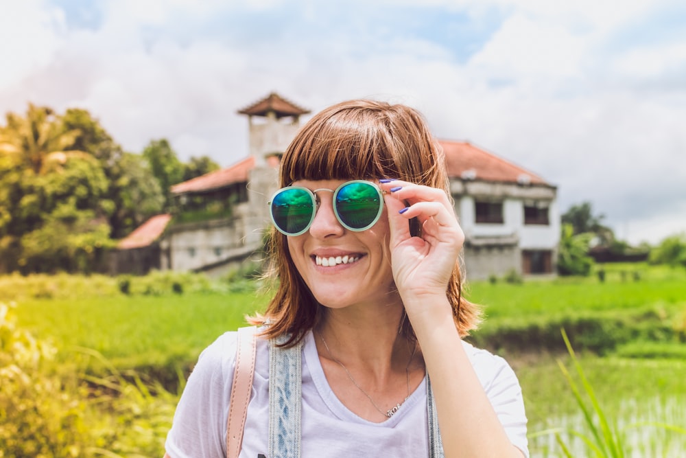 woman holding sunglasses