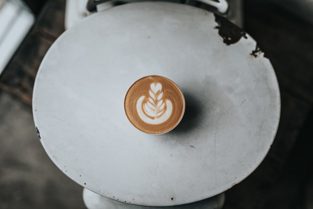 teacup with cappuccino on table