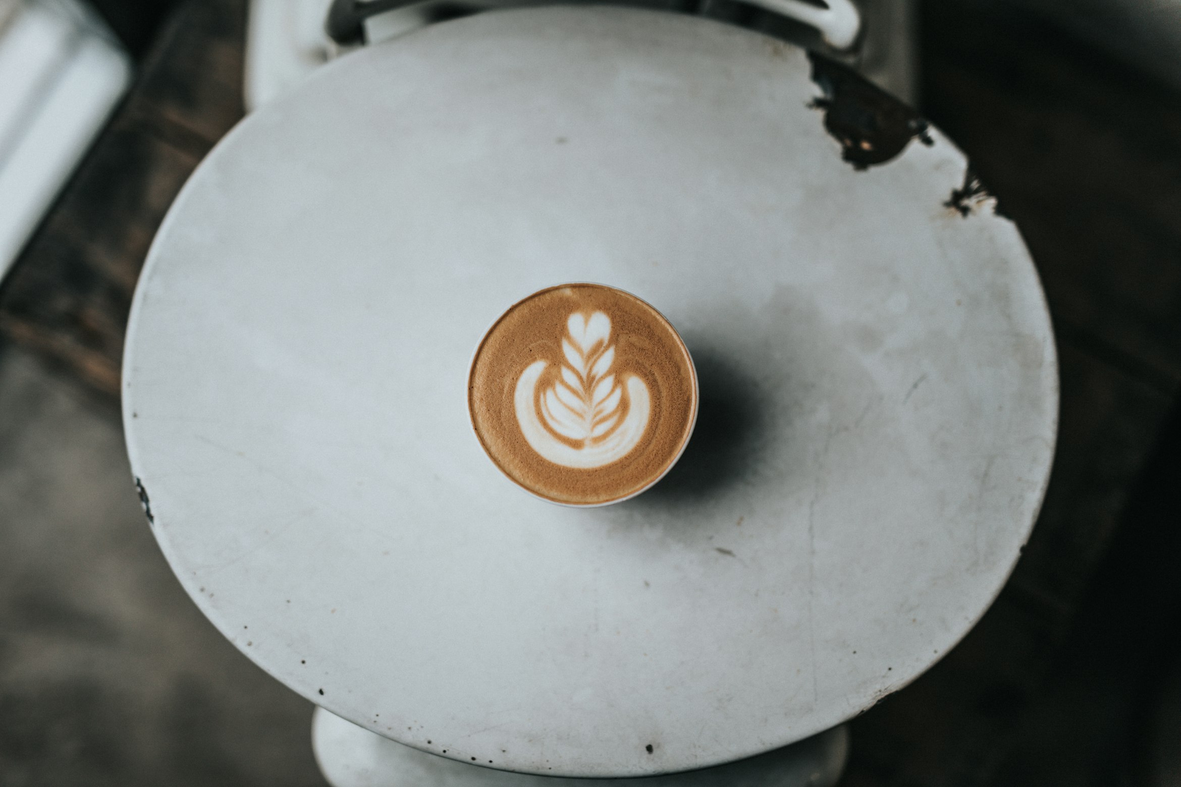 A barista carefully preparing a pour-over coffee.