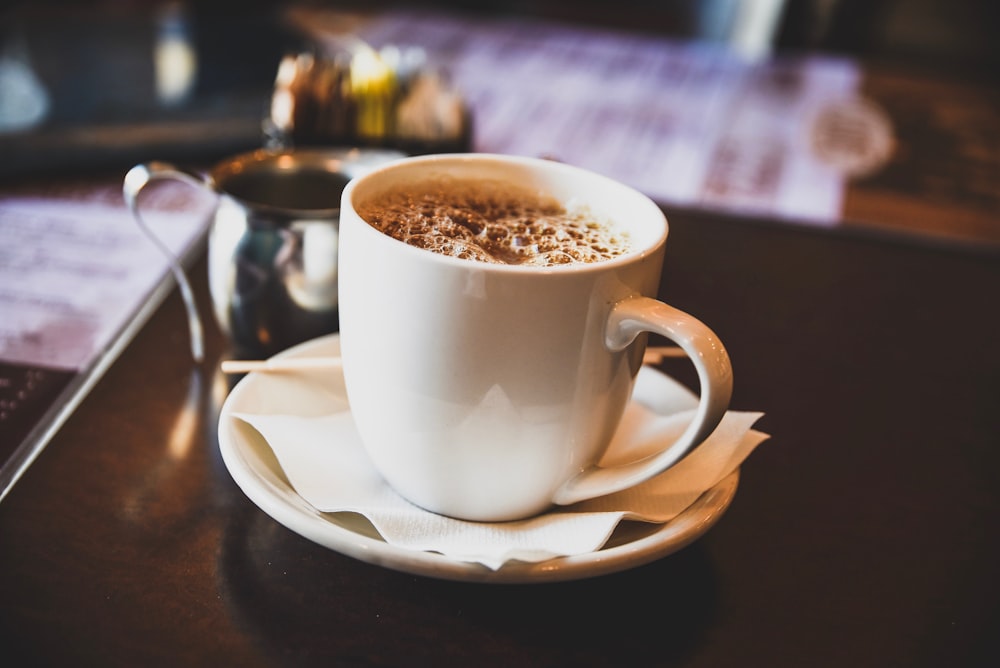 beverage filled mug on saucer on table