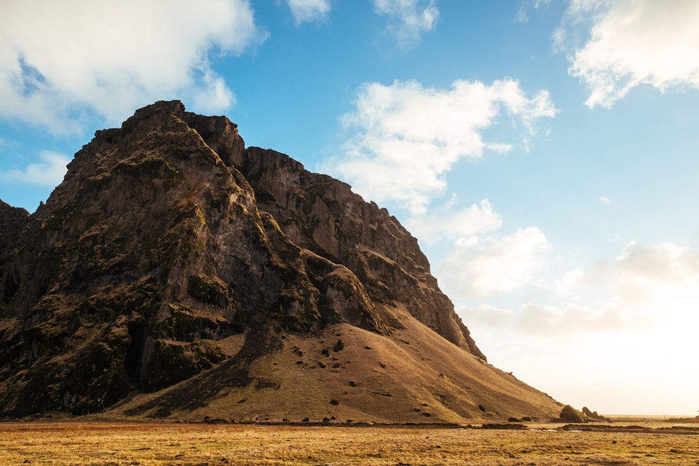 mountain under cloudy blue sky