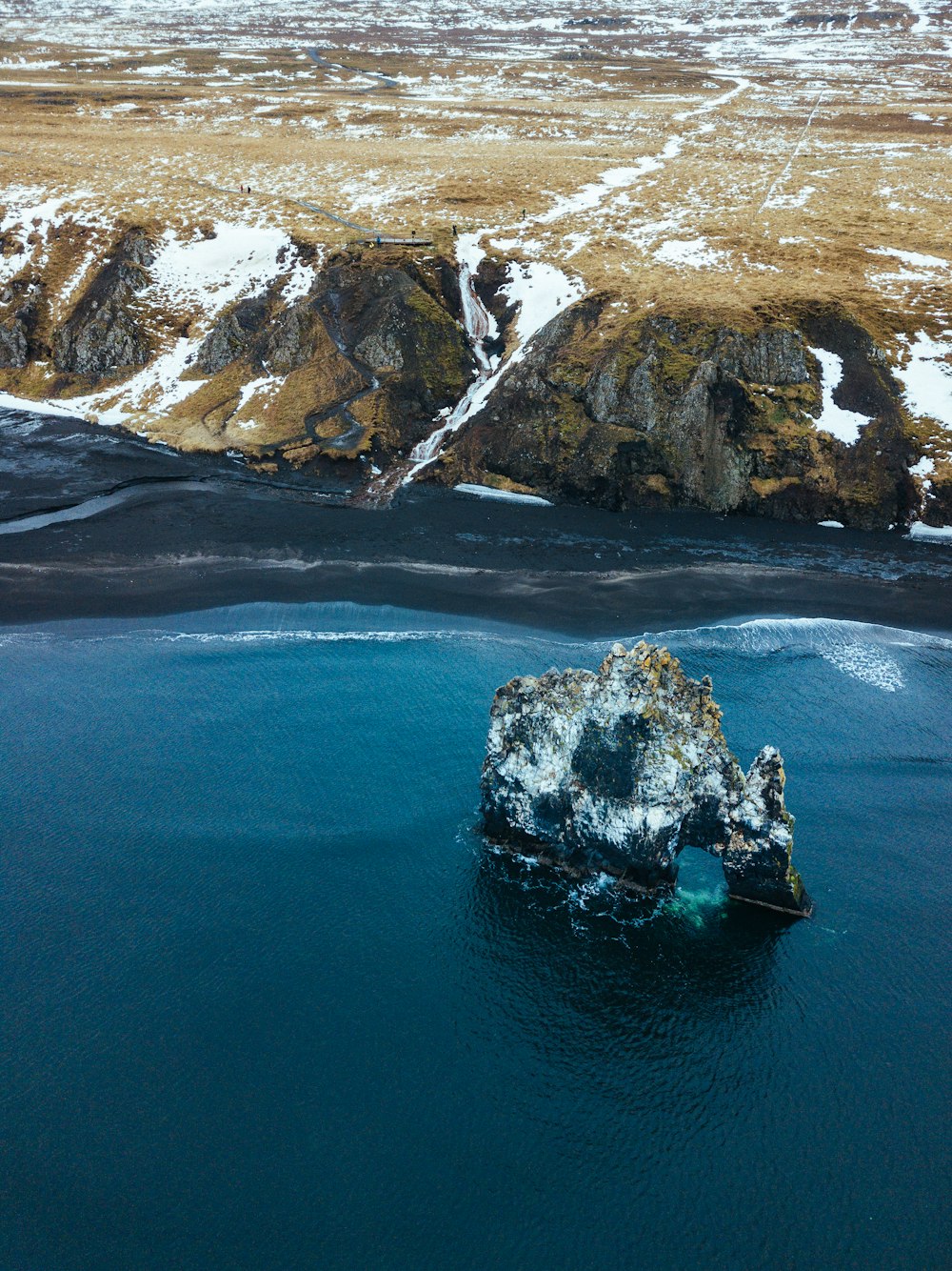 high-angle photography of hill near body of water