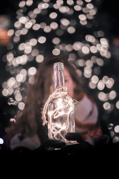 Selective focus photography of string lights on bottle photo – Free