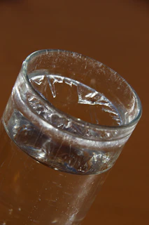 A close-up of a gleaming copper glass filled with water, highlighting its smooth, polished surface.