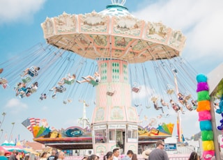 people riding on coaster at daytime