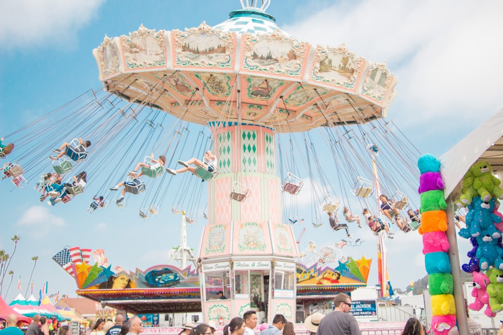 people riding on coaster at daytime