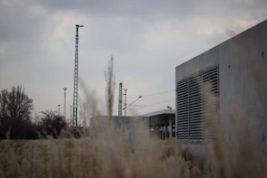 Industrial factory site with visible Corronite earthing rods and conductive concrete pads under bright daylight.
