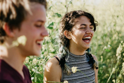 A candid photo of her laughing with close friends in a sunlit garden.
