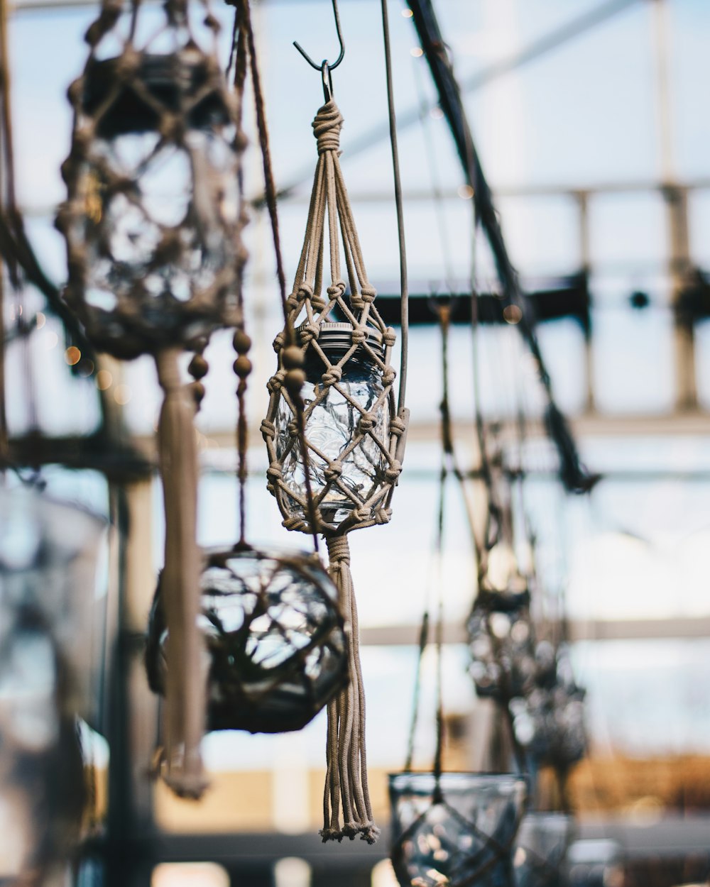 shallow focus photo of hanging glass jar decor