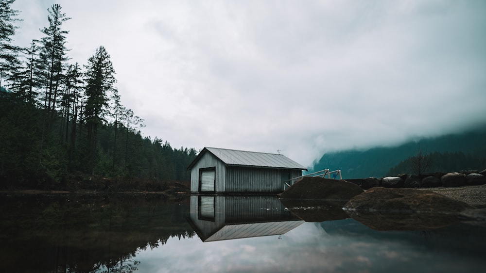 boat shed beside the lake and trees