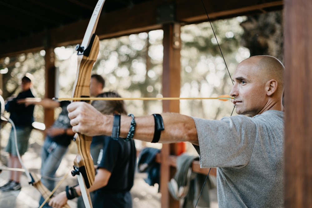 man using a brown bow