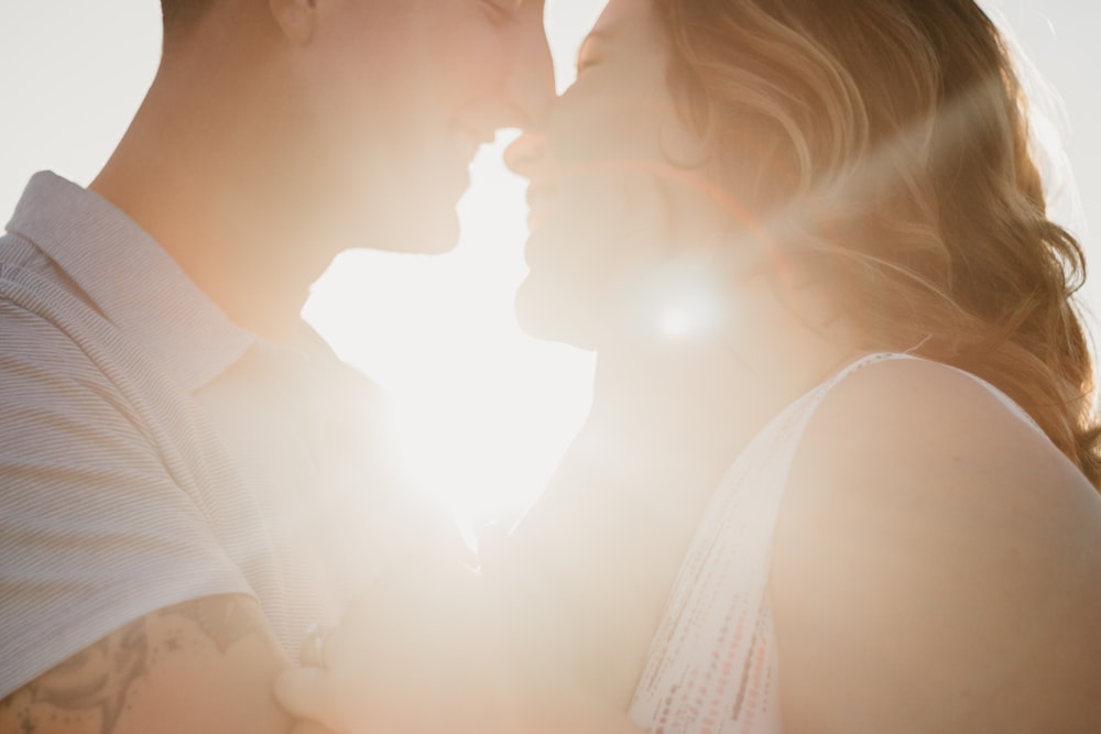 man holding woman's face during daytime