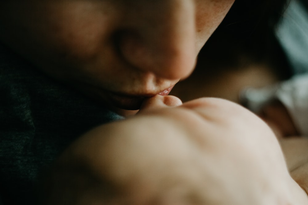 woman kissing baby