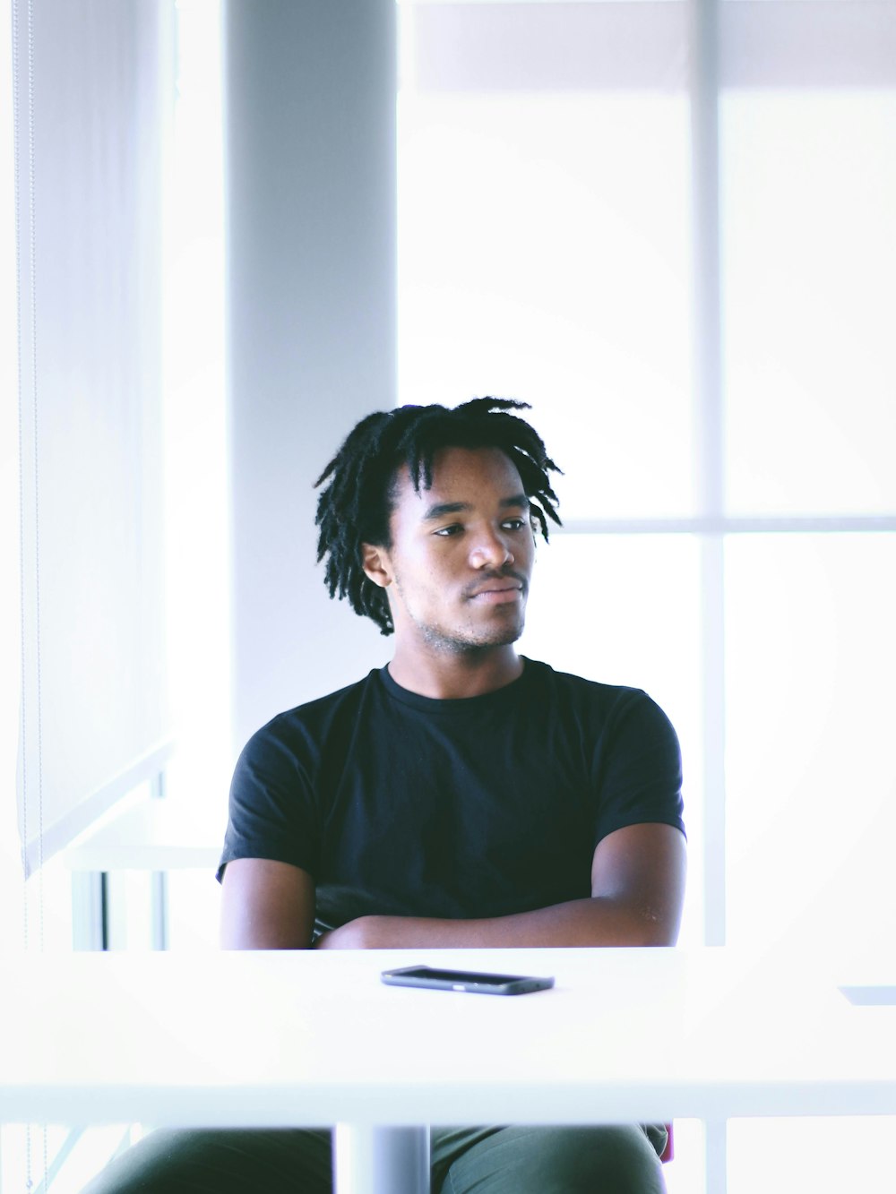 man seating in front of white table