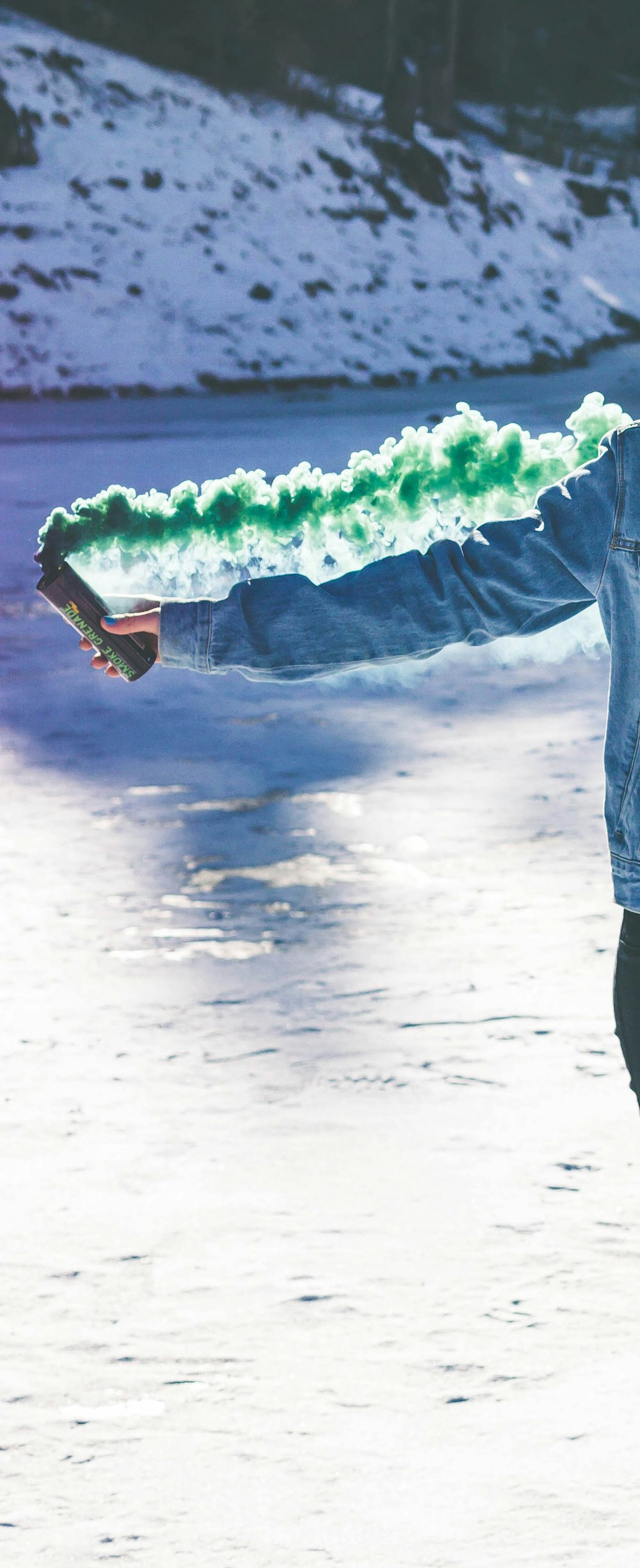 person holding green smoke can