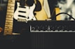 black guitar amplifier beside electric guitar