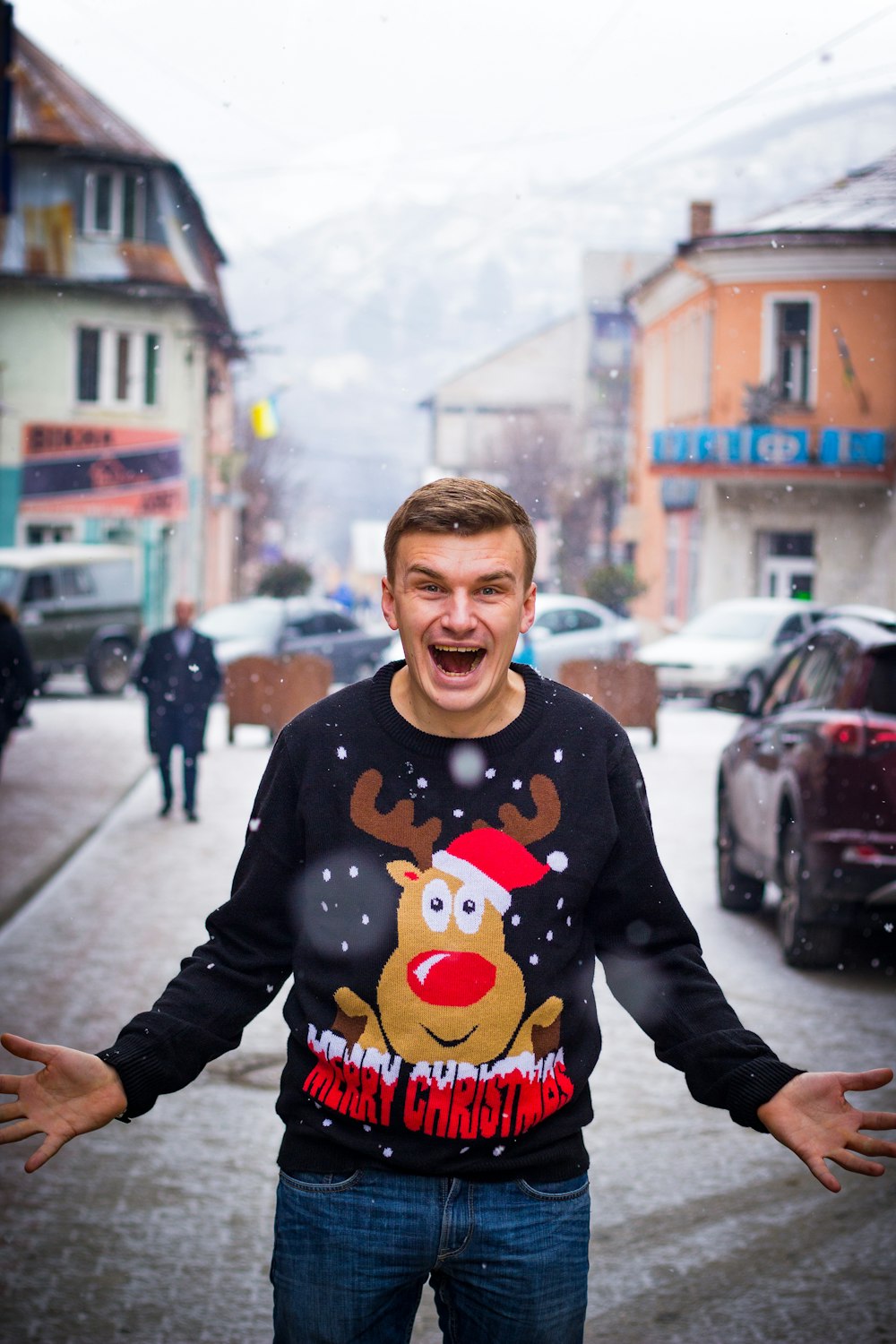 selective focus photography of man standing near car and concrete houses