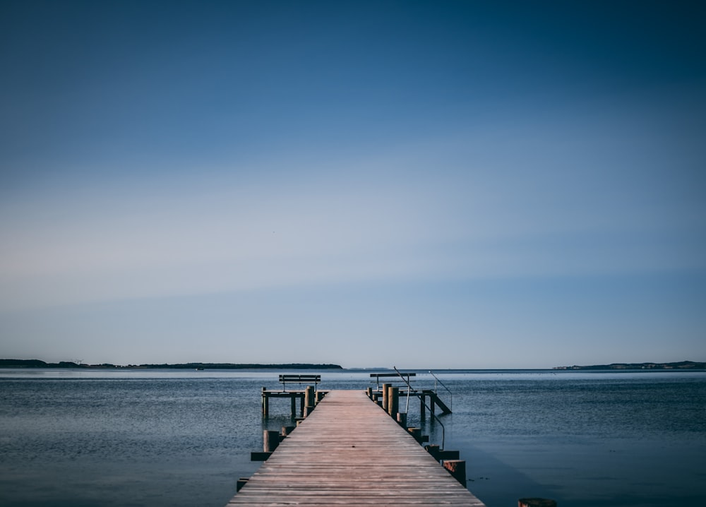 dock bridge beside body of water