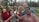 A diverse group of happy clients sharing their positive real estate experiences outdoors.