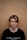 man in black crew-neck shirt near brown wall