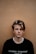 man in black crew-neck shirt near brown wall