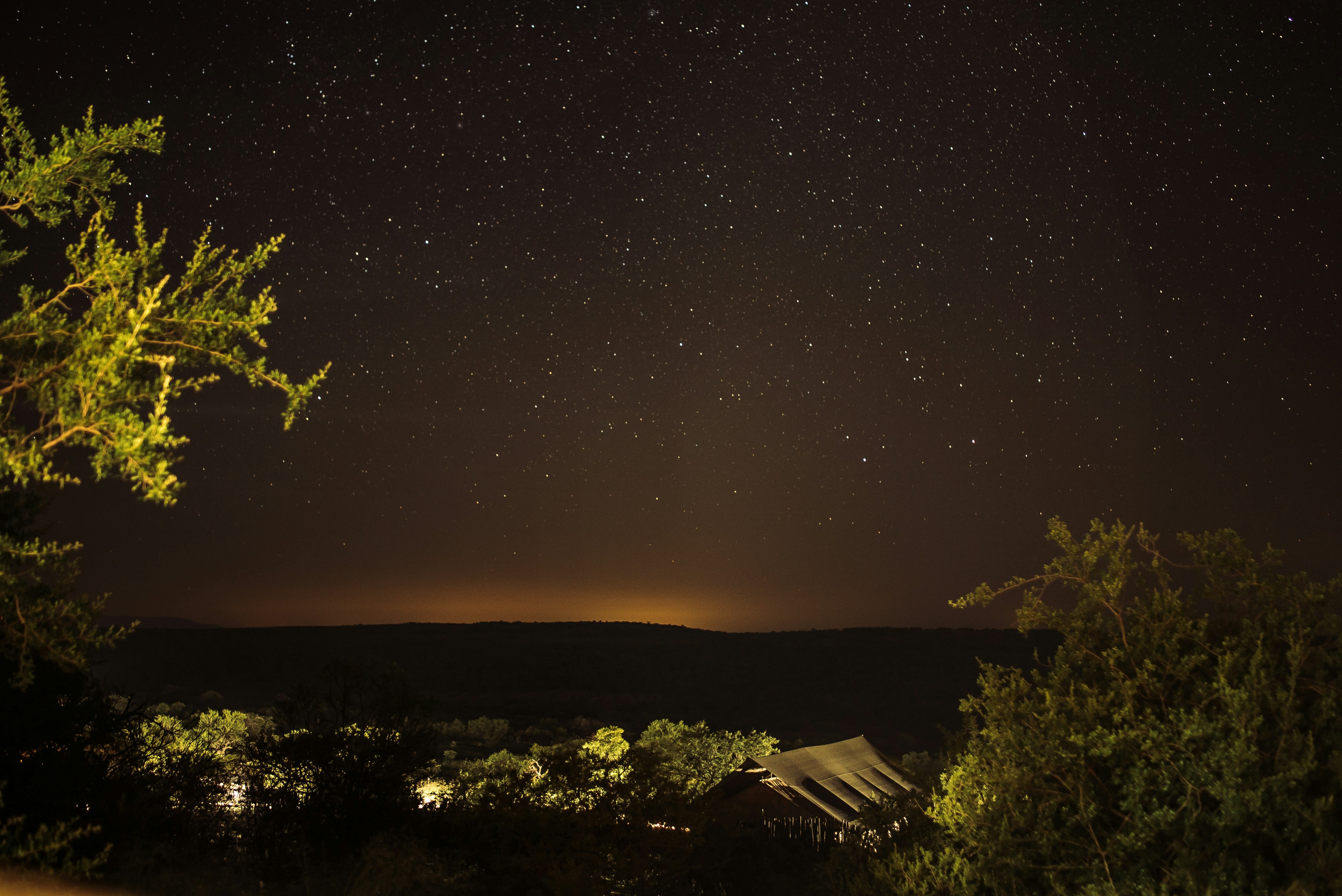 silhouette of mountain under night stars, Camping in the open bush in South Africa.