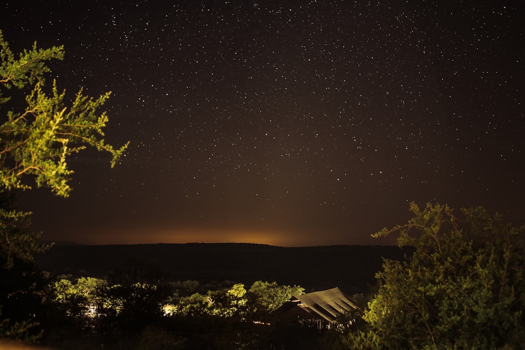 silhouette of mountain under night stars, Camping in the open bush in South Africa.