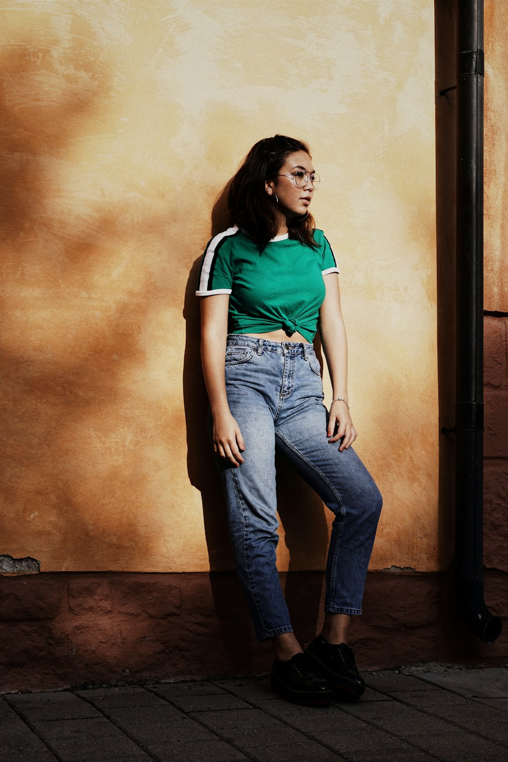 woman leaning on wall