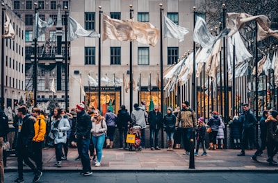 people standing near white and brown flags during daytime