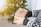 Close-up of hands exchanging a gift card wrapped with a ribbon