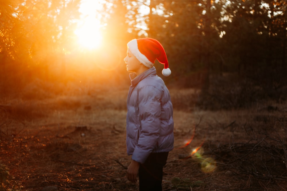 person standing at the woods during sunset