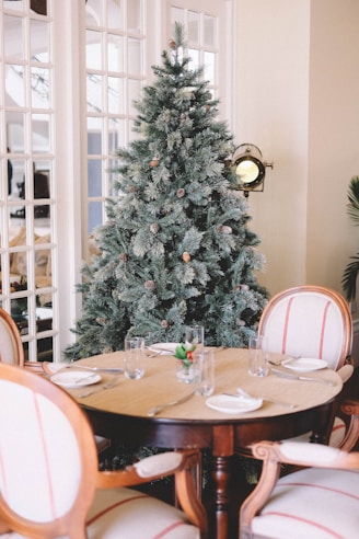 pre-lit tree behind dining set