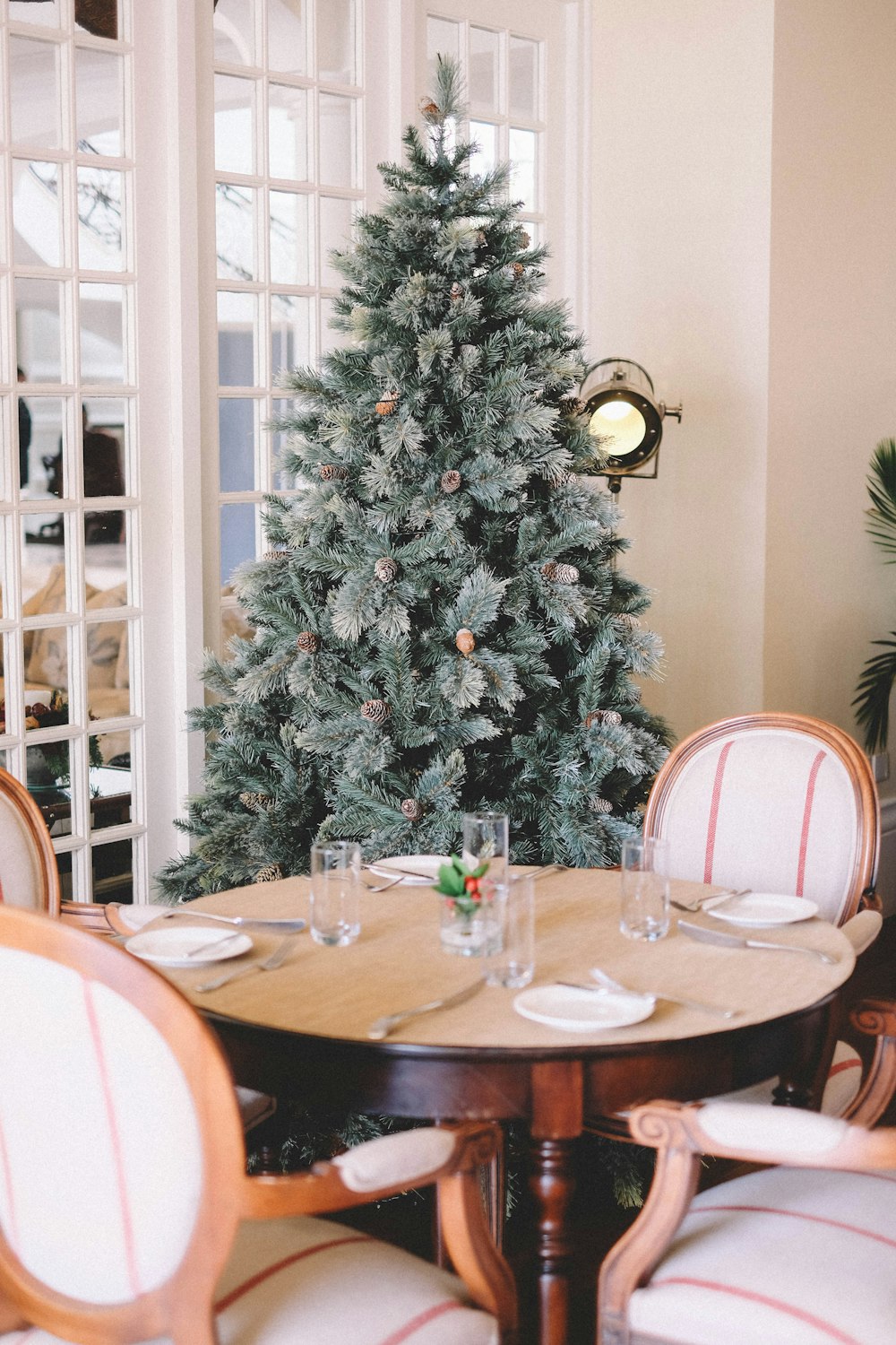 pre-lit tree behind dining set