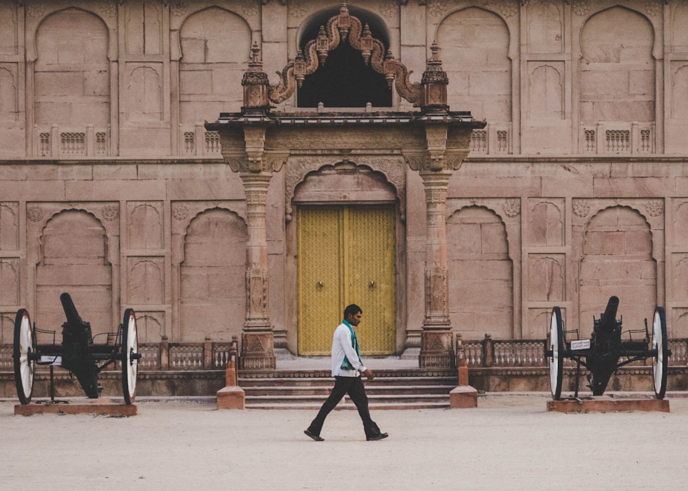 A guy walking nearby a fort