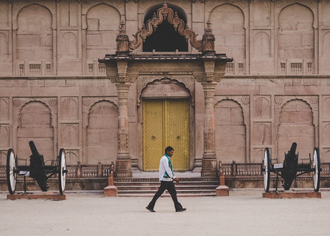 man walking on street in Junagarh Fort India